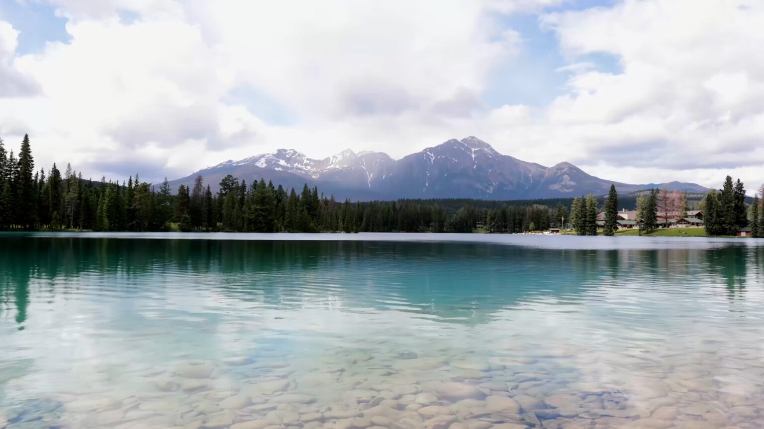 Scenic photo of a lake and mountain in the distance