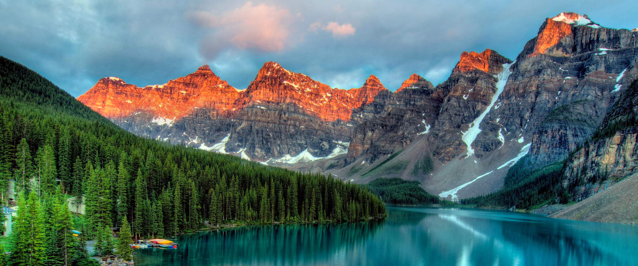 Scenic mountains photo with blue lake and green trees