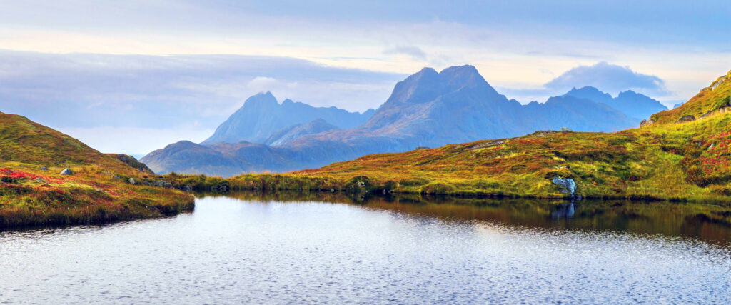 Scenic photo of blue mountains and a lake